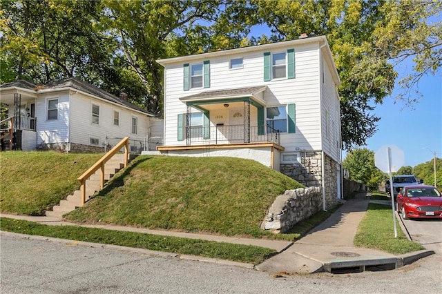 view of front of property with a front yard and a porch