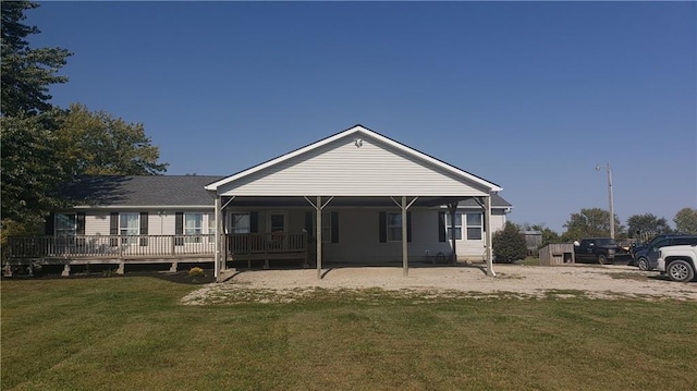 rear view of property featuring a lawn