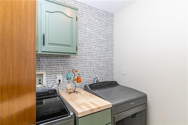 kitchen with tasteful backsplash, washer and dryer, and green cabinetry