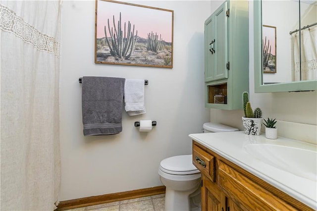 bathroom with tile patterned floors, vanity, and toilet