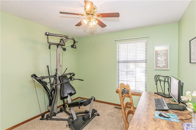 exercise room with carpet floors and ceiling fan