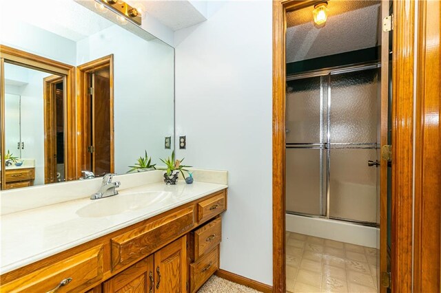 bathroom with vanity and an enclosed shower