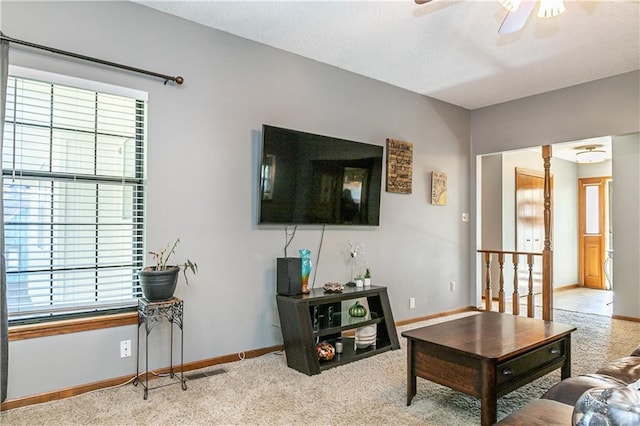 living room featuring carpet flooring and ceiling fan