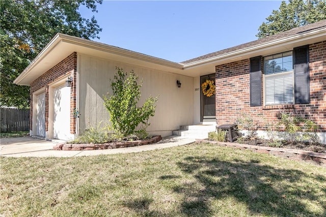 view of front of house with concrete driveway, an attached garage, fence, a front lawn, and brick siding