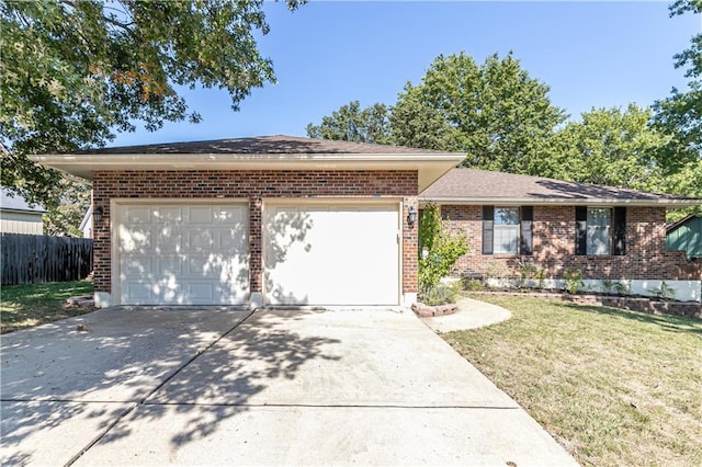 ranch-style house with driveway, brick siding, an attached garage, and a front yard