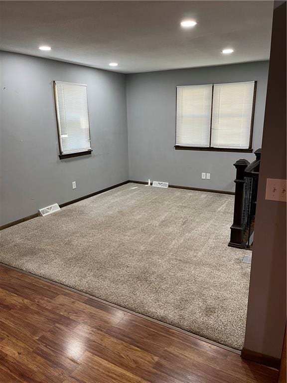 unfurnished room with wood-type flooring