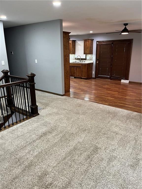 unfurnished living room with ceiling fan and dark hardwood / wood-style floors