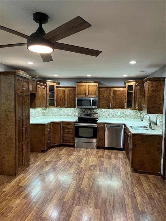 kitchen with dark hardwood / wood-style flooring, appliances with stainless steel finishes, and sink