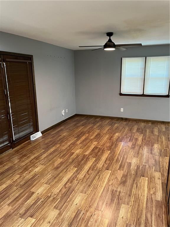 spare room with wood-type flooring and ceiling fan