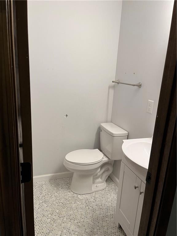 bathroom featuring tile patterned flooring, vanity, and toilet