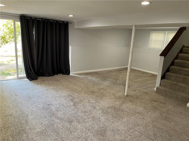 basement with a wealth of natural light and carpet floors