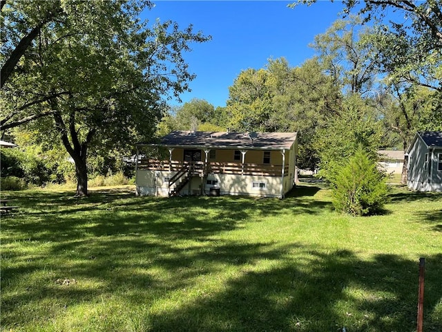 rear view of property featuring a lawn