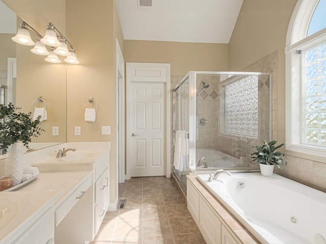 bathroom featuring independent shower and bath, vanity, and tile patterned flooring