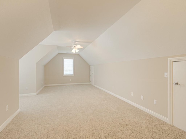 bonus room featuring ceiling fan, vaulted ceiling, and light carpet