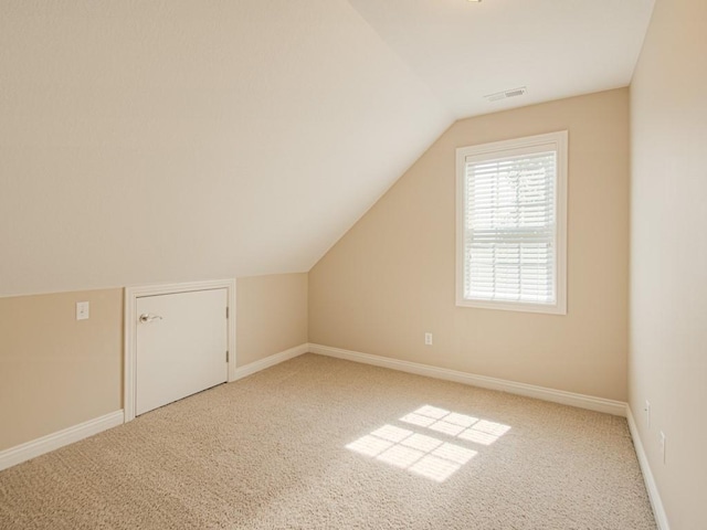 additional living space with lofted ceiling and carpet floors