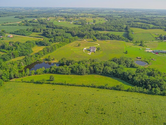 birds eye view of property featuring a water view and a rural view