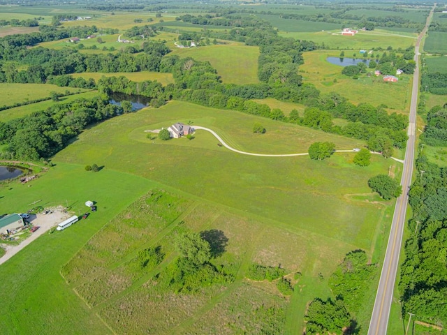 drone / aerial view with a water view and a rural view