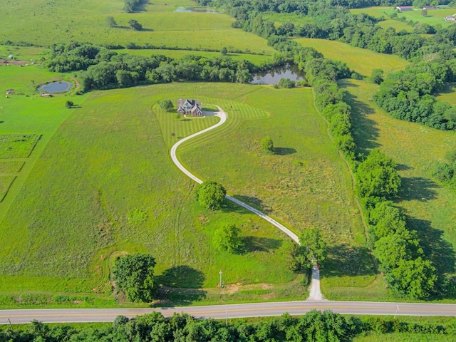 birds eye view of property with a water view and a rural view