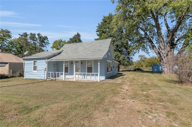 view of front of home with a front yard and covered porch