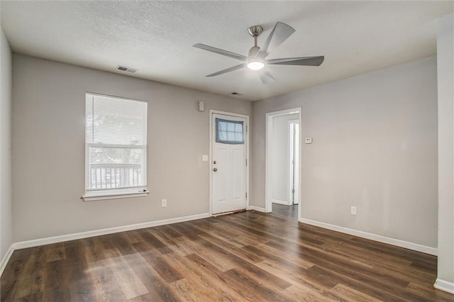 entryway with ceiling fan, a textured ceiling, and dark hardwood / wood-style flooring