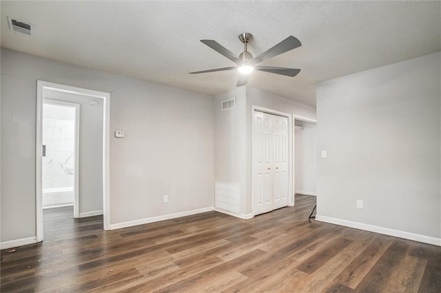 spare room with ceiling fan and dark hardwood / wood-style floors