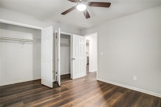 unfurnished bedroom featuring ceiling fan and dark hardwood / wood-style floors