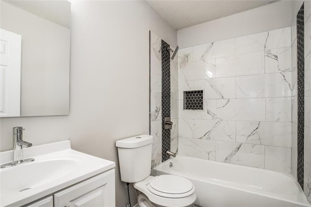 full bathroom with vanity, toilet, and tiled shower / bath combo