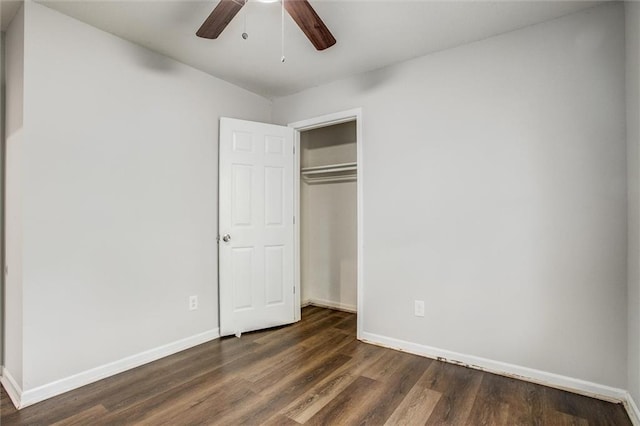 unfurnished bedroom with dark hardwood / wood-style flooring, a closet, and ceiling fan