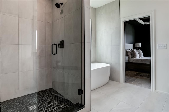 bathroom featuring separate shower and tub and tile patterned flooring