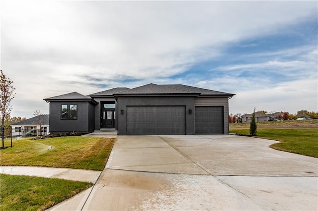 view of front of home with a front yard and a garage