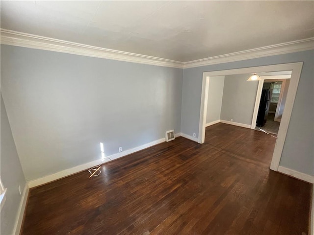 unfurnished room featuring ornamental molding and dark wood-type flooring