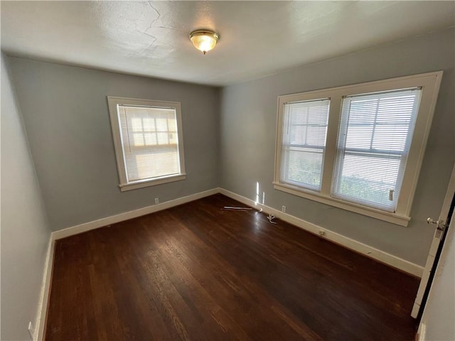 empty room with dark wood-type flooring