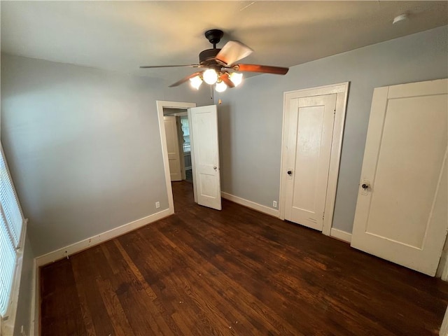 unfurnished bedroom with ceiling fan and dark hardwood / wood-style flooring