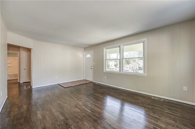 spare room with dark hardwood / wood-style flooring