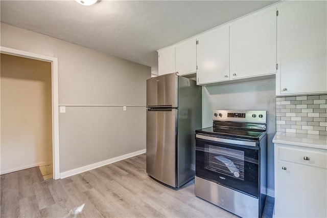 kitchen featuring white cabinetry, light hardwood / wood-style floors, stainless steel appliances, and tasteful backsplash