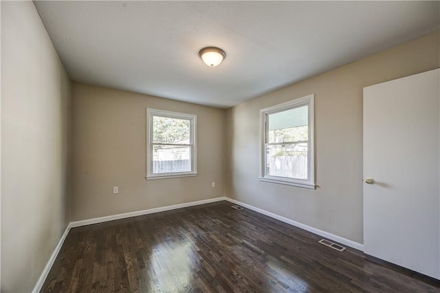 unfurnished room featuring dark wood-type flooring