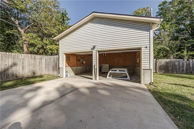 garage featuring a yard and wood walls