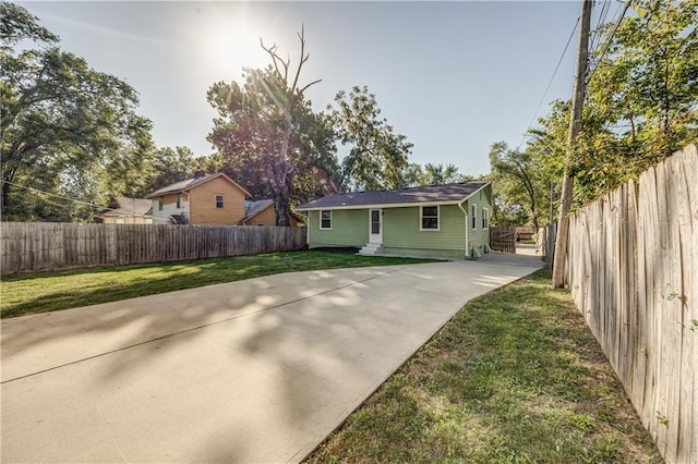 back of property with a yard and a patio area