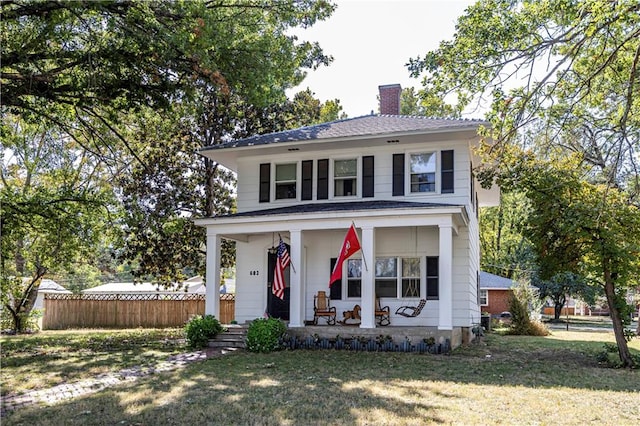 view of front of property with a porch and a front lawn