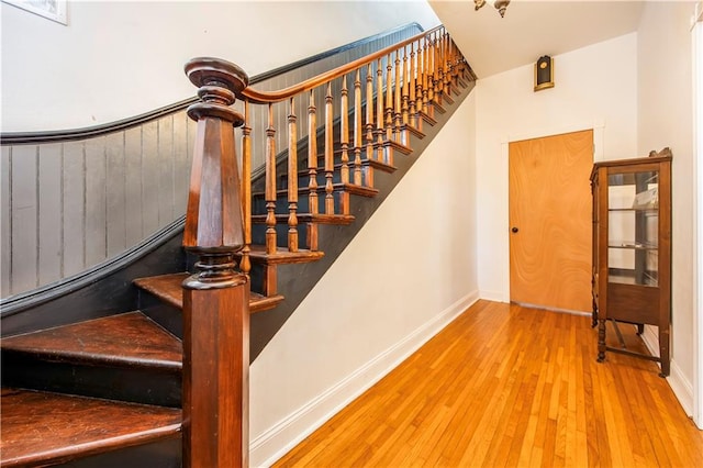 stairway with hardwood / wood-style flooring