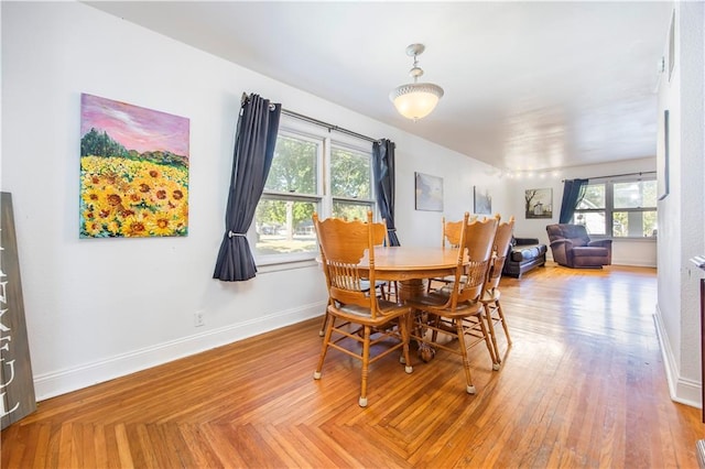 dining area with plenty of natural light and wood-type flooring