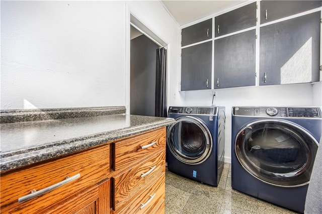 laundry room with washer and dryer and cabinets