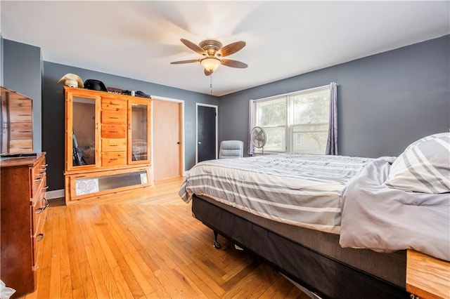 bedroom featuring light wood-type flooring and ceiling fan