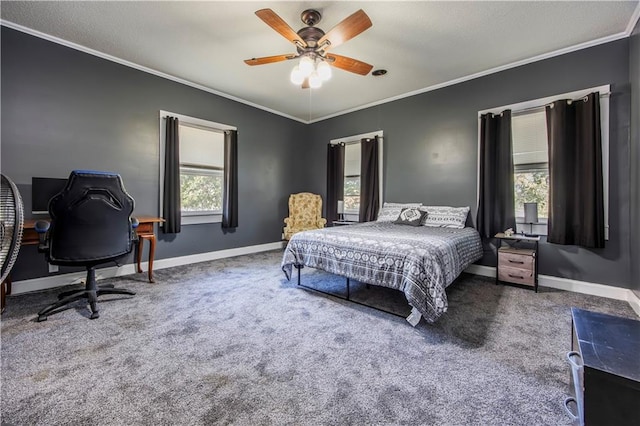 bedroom with carpet floors, ornamental molding, multiple windows, and ceiling fan