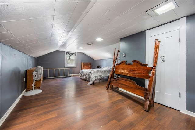 bedroom with vaulted ceiling and hardwood / wood-style floors