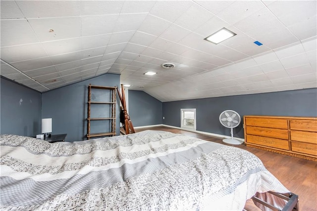 bedroom featuring lofted ceiling and hardwood / wood-style flooring