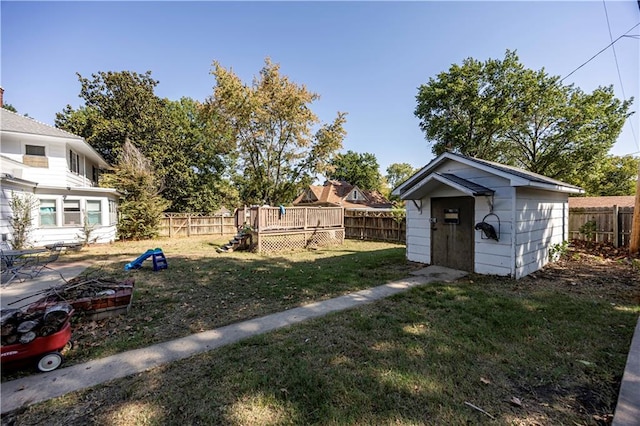 view of yard featuring a storage shed and a deck