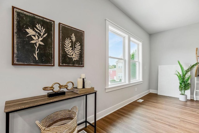 interior space featuring wood finished floors, visible vents, and baseboards