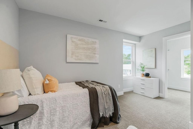 bedroom with baseboards, visible vents, and carpet floors