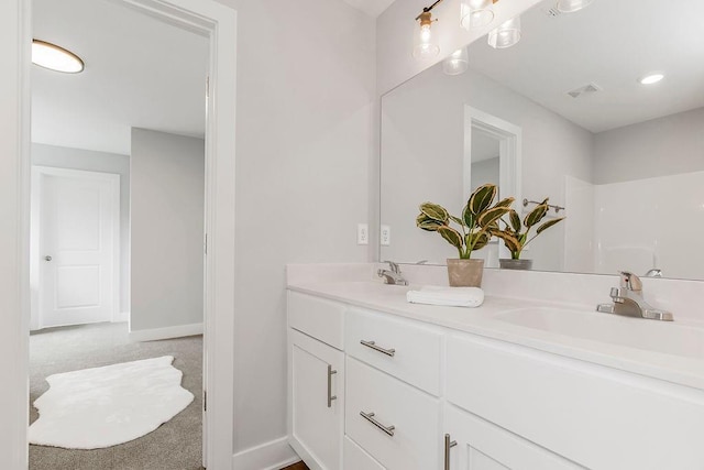 bathroom featuring a shower and vanity